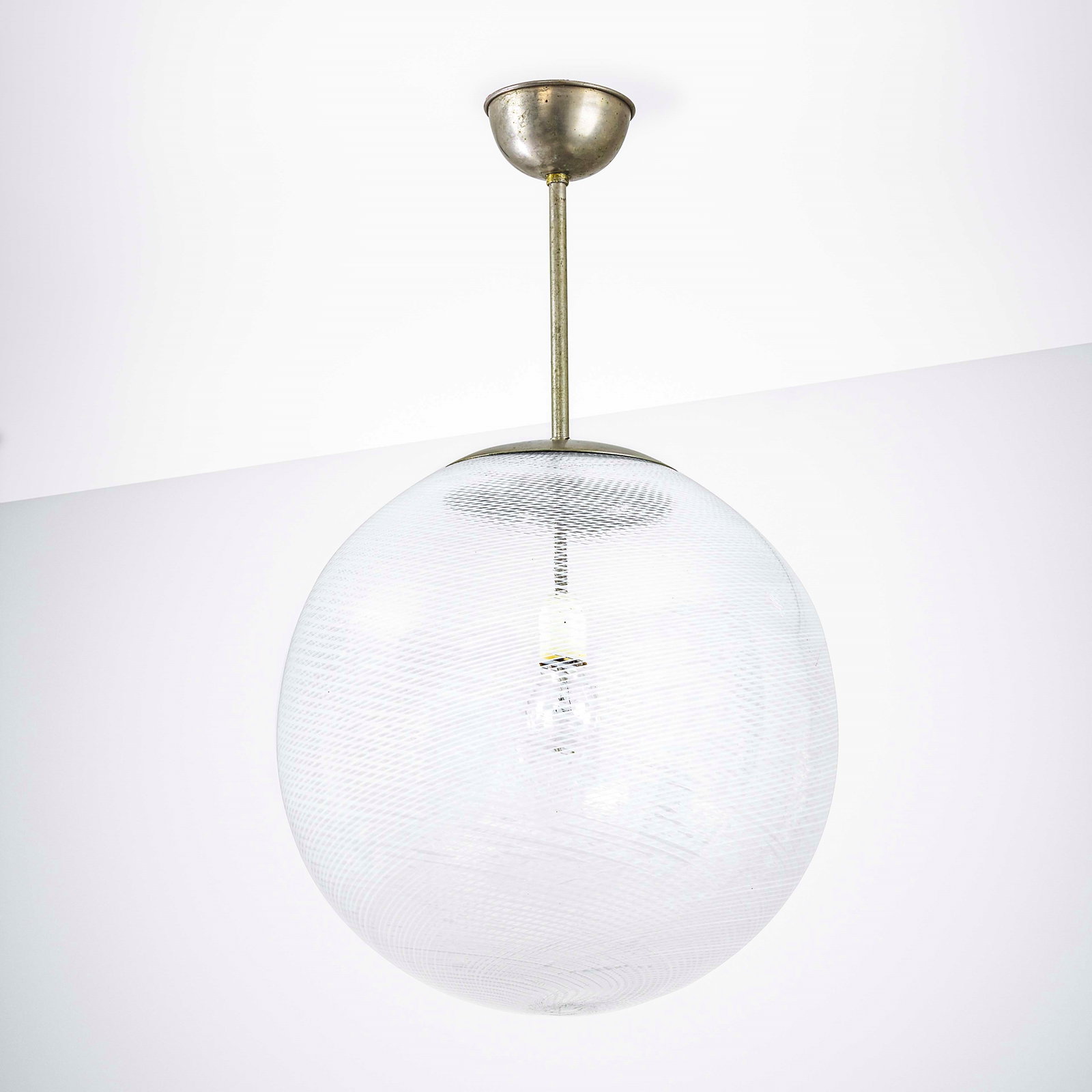 Carlo Scarpa Pendant lamp: Metal structure, Murano glass diffuser with Reticello decoration. Venini, Italy, c. 1940. M. Barovier, C. Sonego, Venini Luce 1921- 1985, p. 564, Skira, 2022 . Measuers: cm 45X70