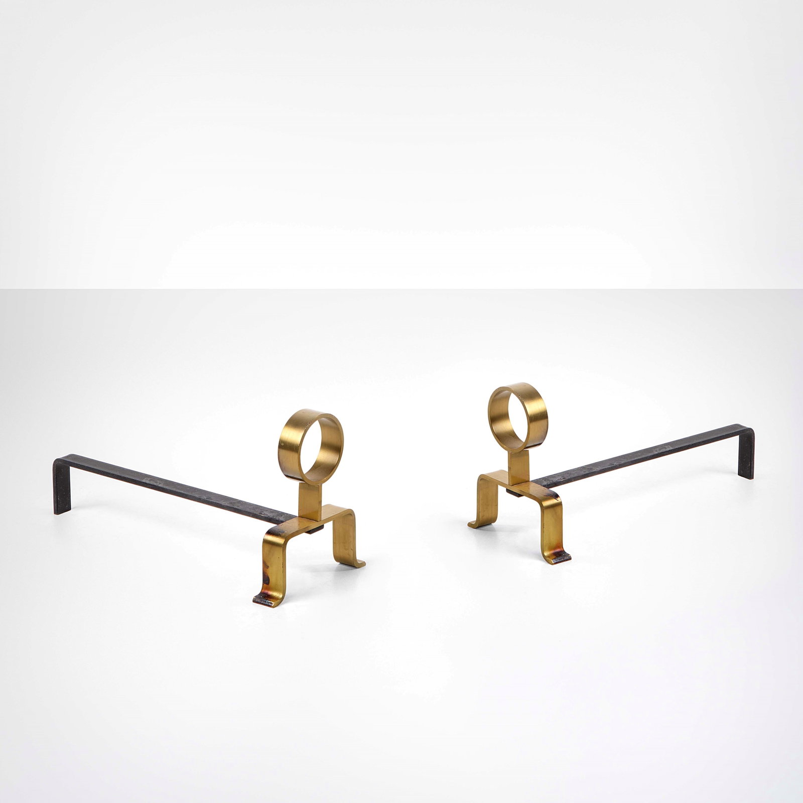 Melchiorre Bega Two andirons: Lacquered metal and brass structure. Bega, Italy, c. 1950. S. Zironi, Melchiorre Bega Architetto, architetture d'interni, p. 75, Editoriale Domus S.A, 1937. . Measuers: W. 20 - D. 48 - H. 24 Cm