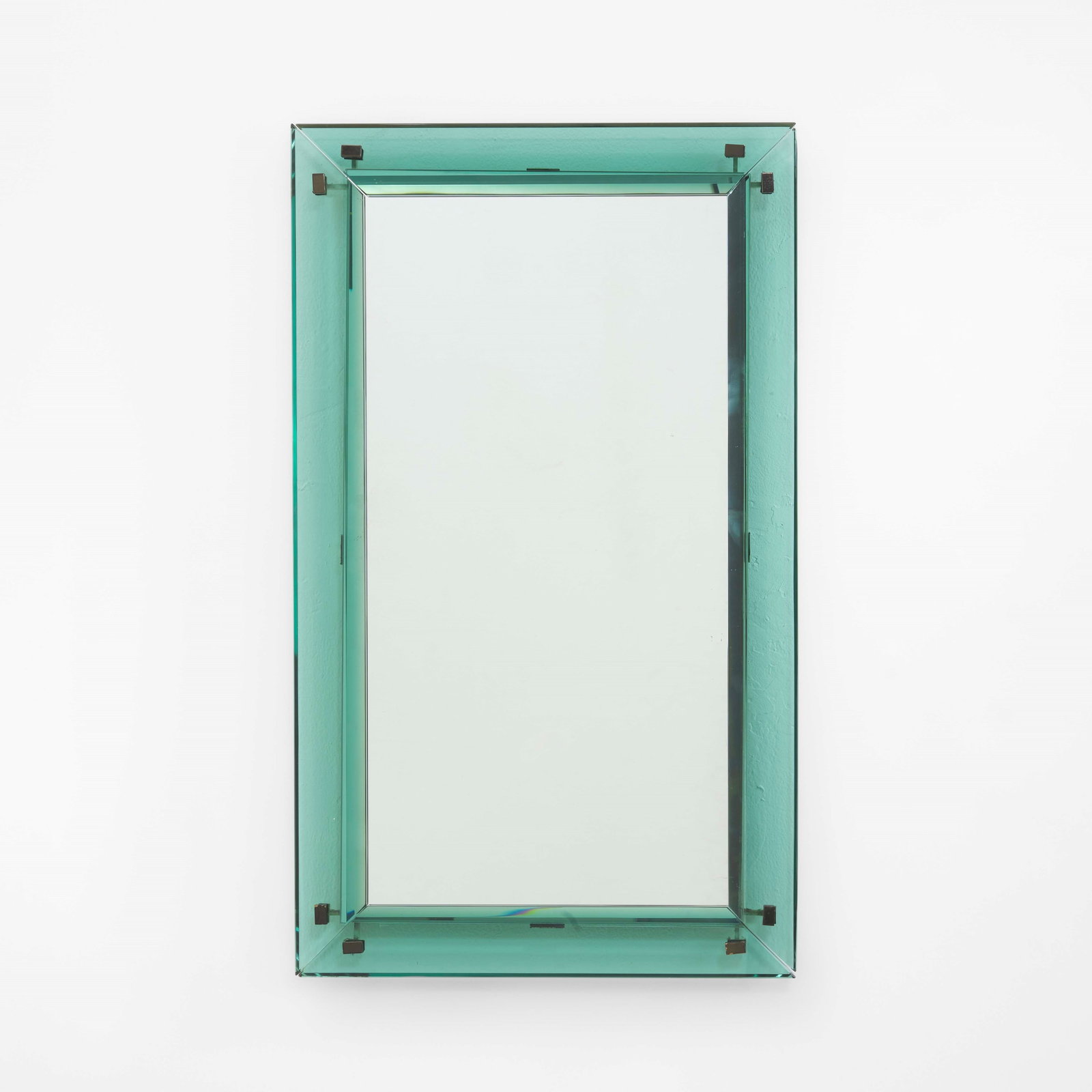 Max Ingrand Wall mirror mod. 2103: Cut and colored glass structure, mirrored glass, and nickel-plated brass details. Original label. Fontana Arte, Italy, c. 1950. Quaderni Fontana Arte . Measuers: cm 50X3X85