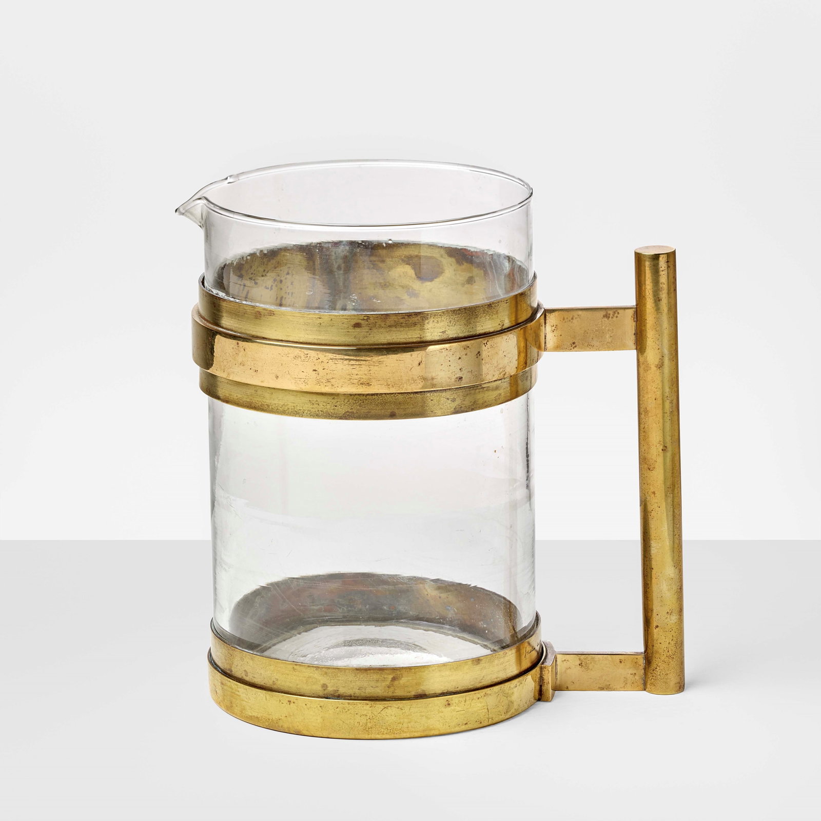 Gabriella Crespi Decanter: Transparent crystal and brass. Engraved signature Prod. Italy, c. 1970. . Measuers: W. 21 - D. 13 - H. 21 Cm