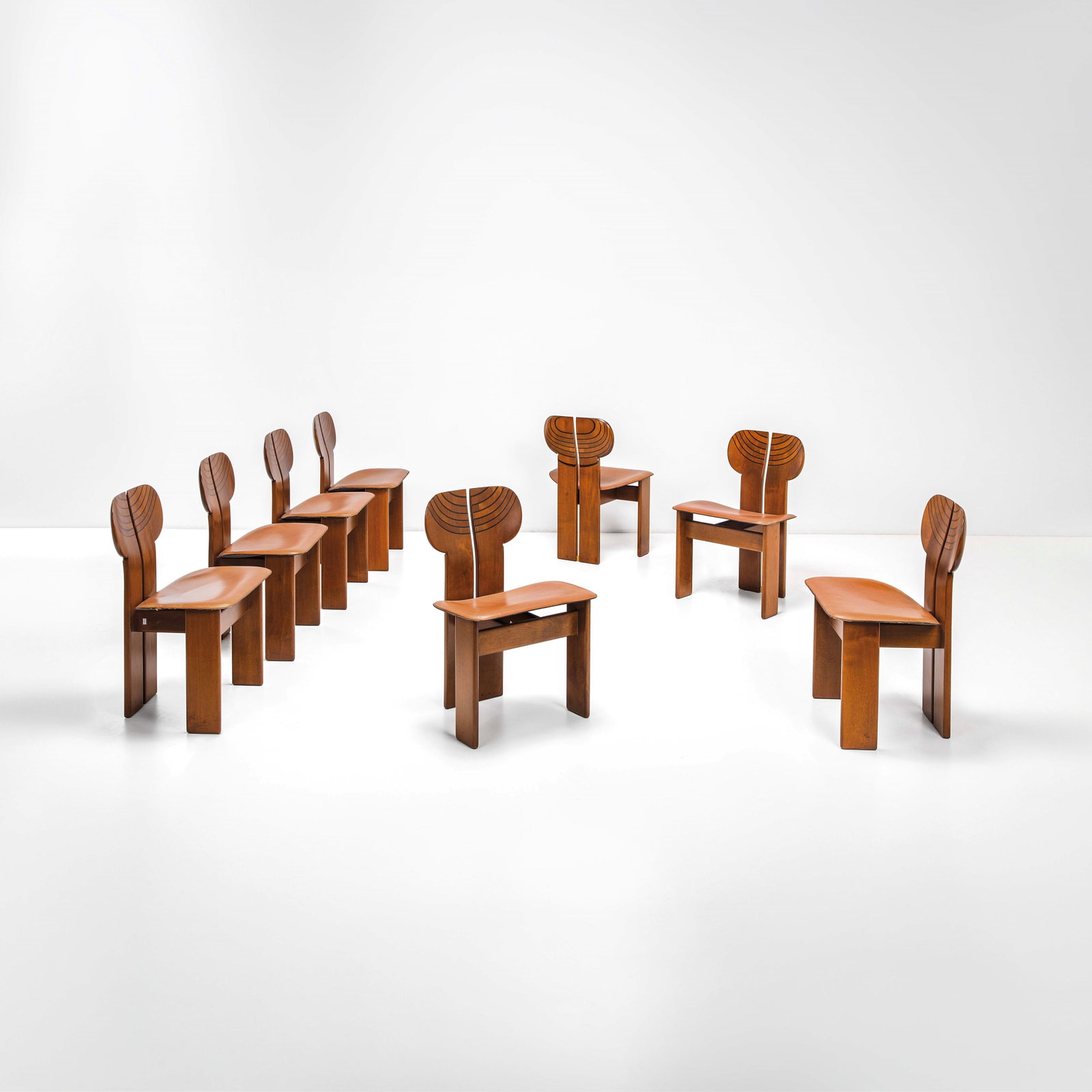 Afra e Tobia Scarpa Eight chairs mod. Africa from the Artona series.: Structure in different wood types. Curved plywood seat covered in leather.Marked. Maxalto, Italy, c. 1970. R. Masiero, Afra e Tobia Scarpa, p. 28, Electa, 1998 M. Mastropietro, Un?industria per il