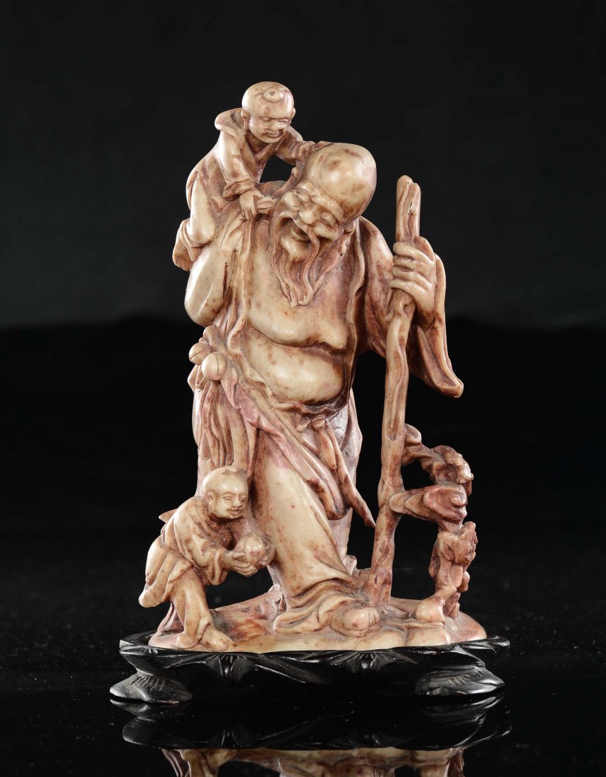 A soapstone "wise man and playing children" group,: h cm 16