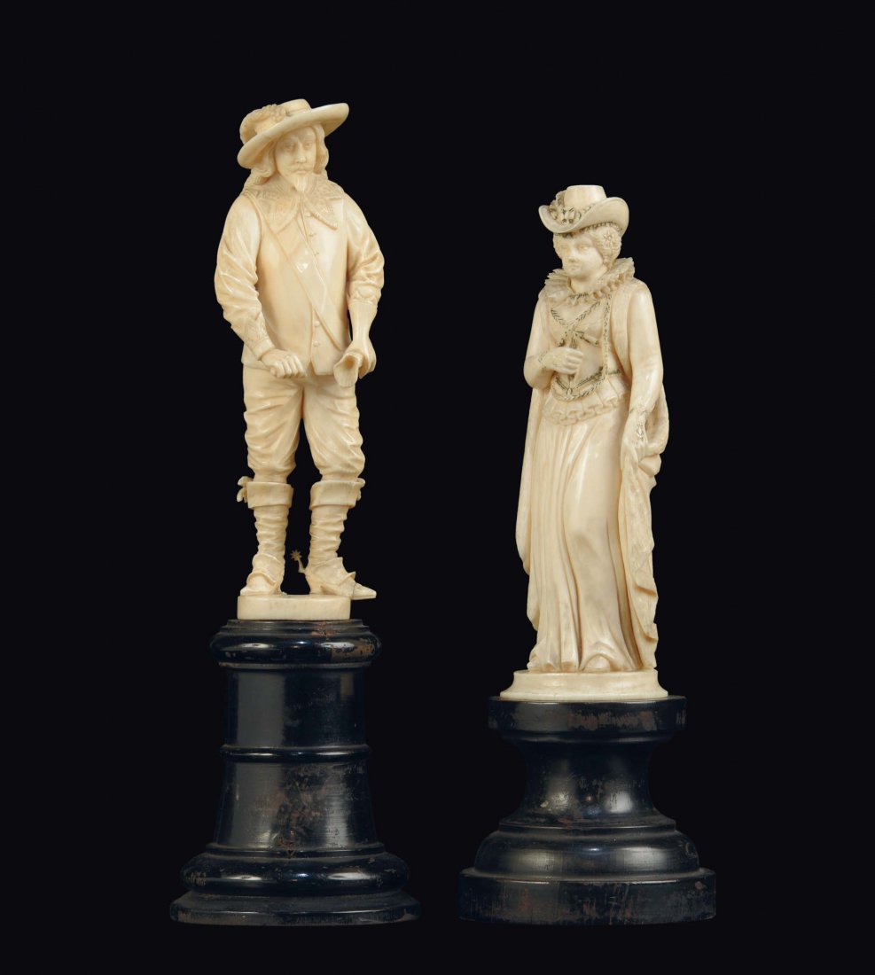 A carved ivory group of two figures representing (1 of 2)