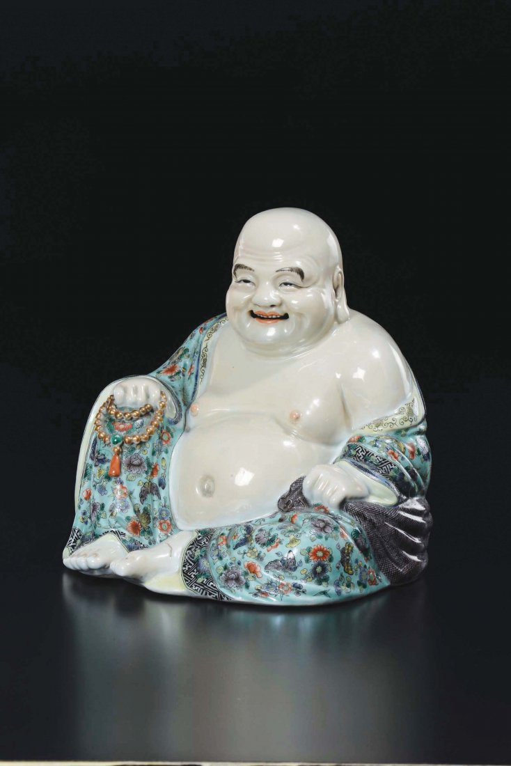 A polychrome enamelled porcelain figure of Budai, (1 of 2)