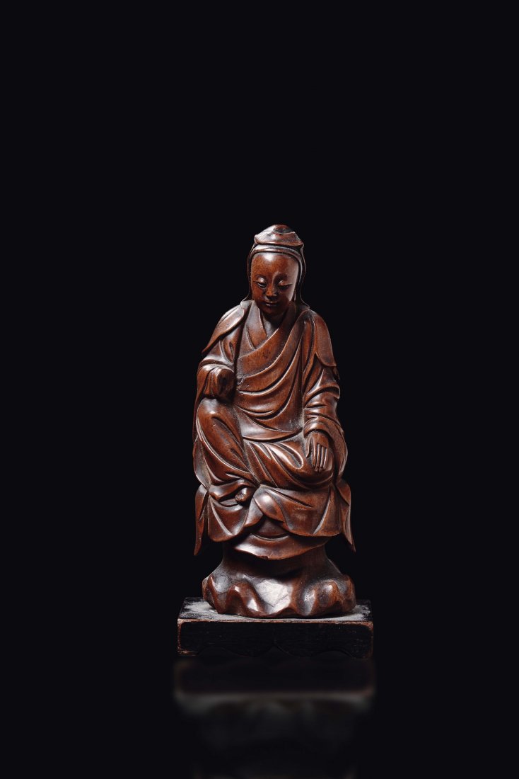 A carved bamboo figure of wise man seated on a rock, (1 of 3)