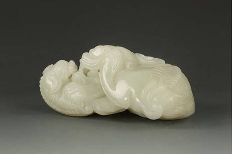 An Chinese Qing dynasty carving white jade,: An Chinese Qing dynasty carving white jade, This well-carved jade ornament is made into the form of a fearsome lion, pouncing onto a smaller lion. They show great ferocity. L: 5 1/2 in (14 cm), W: 3