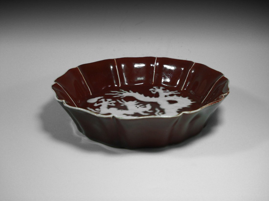 A CHINESE QING RED GLAZE PORCELAIN PLATES.BOWL.: A Chinese Qing Red glaze porcelain plates.bowl. This red bowl has a figure of a dragon in the middle of the inner bowl and the bowl is shpaed as a lotus, six characters Xuande mark on the bottom.D 8"