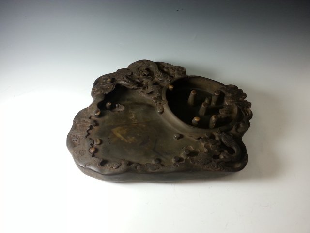 DOUBLE DRAGON INKSTONE WITH EYES: Two carved dragons on inkstone and the concern has many little rods pointing up. L: 12 in W: 10.7 in (HJ)
