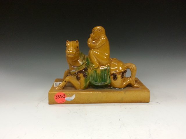 MONKY RIDING ON A HORSE DECORDATION: A decordation showing a monky riding on a horse, meaning going to be at a higher position very soon. The horse is sitting down and the monkey has a post of a monk. W 8.75"