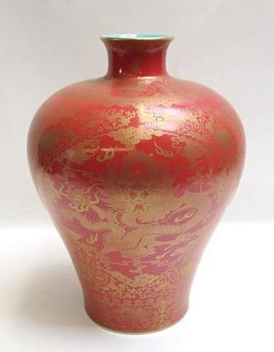 RED GROUND GILT DRAGON FIGURE VASE: This vase is of red background color filled with glit dragon figure. The inner area is of blue glazed. A six characters Qianlong mark on the bottom.