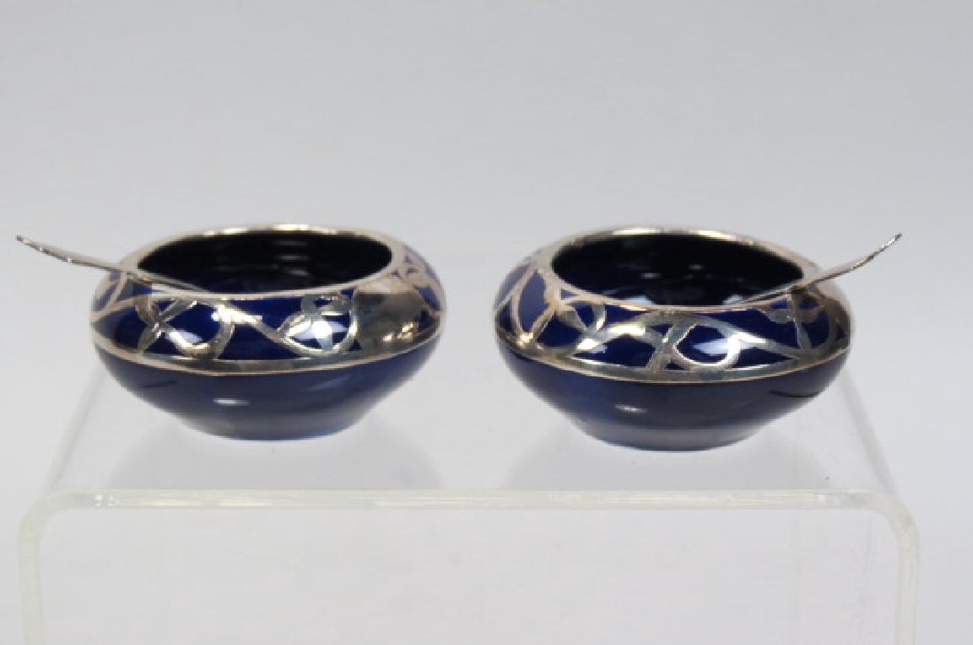 Pair of Silver Overlay Porcelain Salt Cellars,: Pair of Silver Overlay Porcelain Salt Cellars, floral on cobalt, 2" diameter, with sterling spoon, excellent.