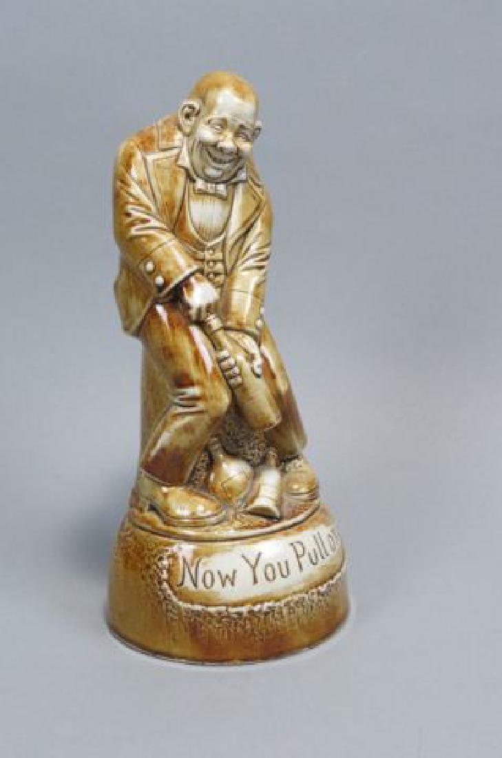 German Porcelain Figural Decanter with Music Box,: German Porcelain Figural Decanter with Music Box, "Now you pull one", man opening wine bottle, plays, "How dry I am" by Shafer & Vater, 11".