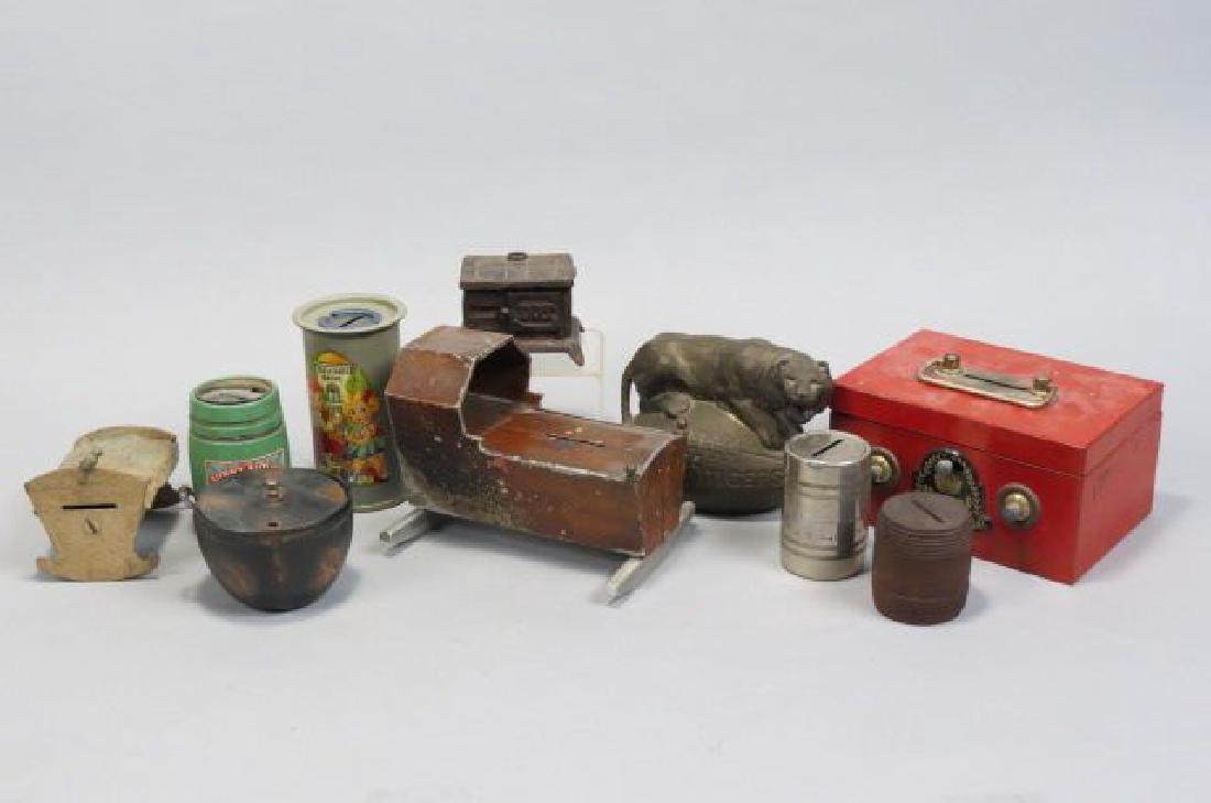 10 pc. Bank Collection;: cast iron stove, baby in cradle, Auburn Tigers football, combination lockbox and more.