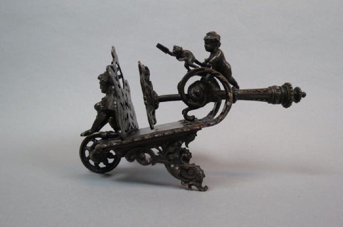 Tiffany Bronze Letter Press,: figural child and monkey at top, female gryphion type creature on end, rococo design, 6" tall, 8 1/2" long, retailer mark of Tiffany & Co.