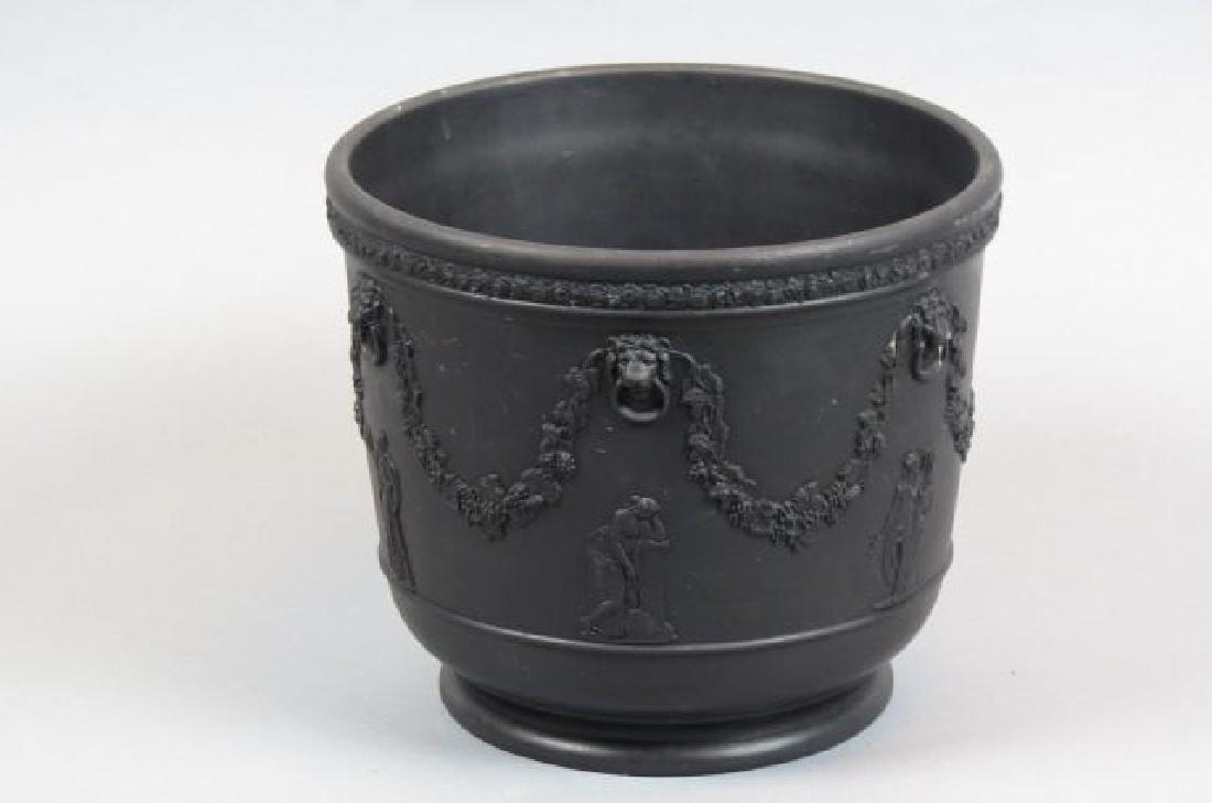 Wedgwood Basalt Jardiniere,: classical figures with grape and vine garland, lion and ring handles, 8" tall, 9" diameter.