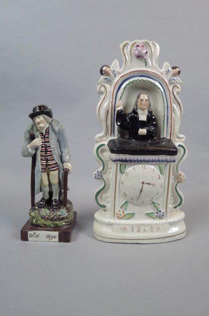 2 Early English Figurines, Staffordshire: "Wesley" figurine for John Wesley, at the pulpit, 11 3/4", and an pearlware style figurine "Old Age", with old man holding crutch and cane, 7 3/4".