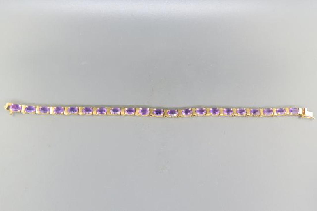Amethyst Bracelet,: 21 oval gems totaling over 8 carats in 14K yellow gold, 7" long, 10.7 grams.