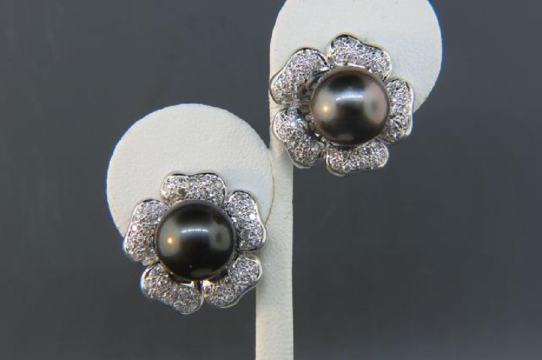 Tahitian Black Pearl & Diamond Earrings,: 12 mm pearls and 100 round diamonds totaling 2 carats, high grade, 18K white gold, with appraisal of $6,950.00, 1" flower style settings.