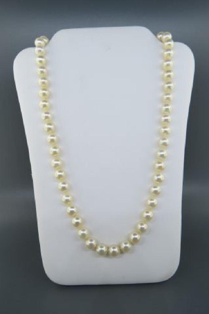 Pearl Necklace,: 51 cream rose 6 mm pearls, 14K white gold clasp with a trio of round diamonds, 14 1/2" long.