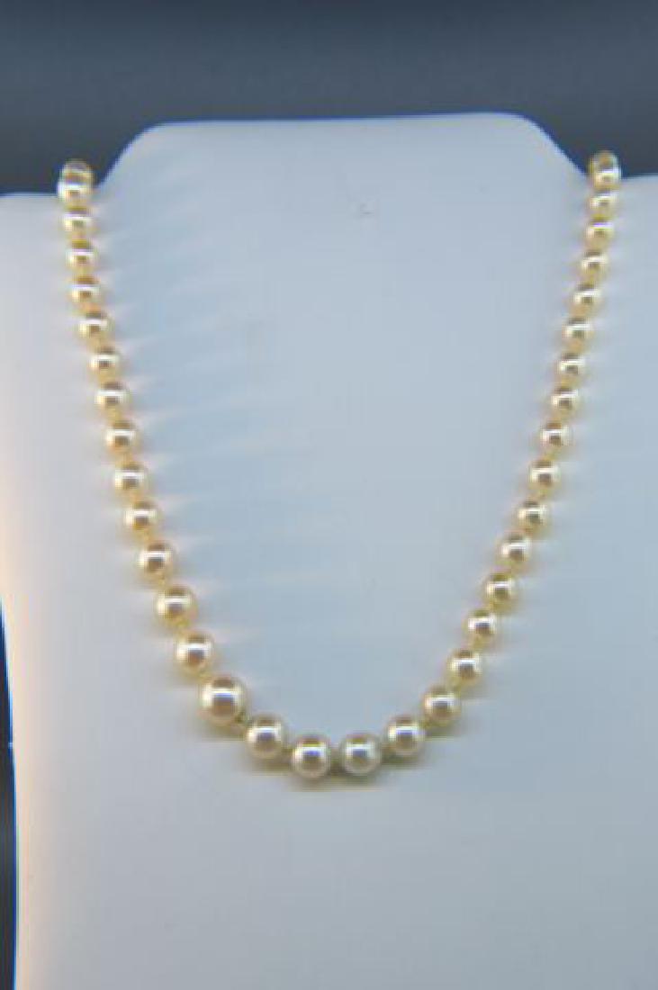 Pearl Necklace,: graduated, 18" long, 14K white gold filigree clasp.