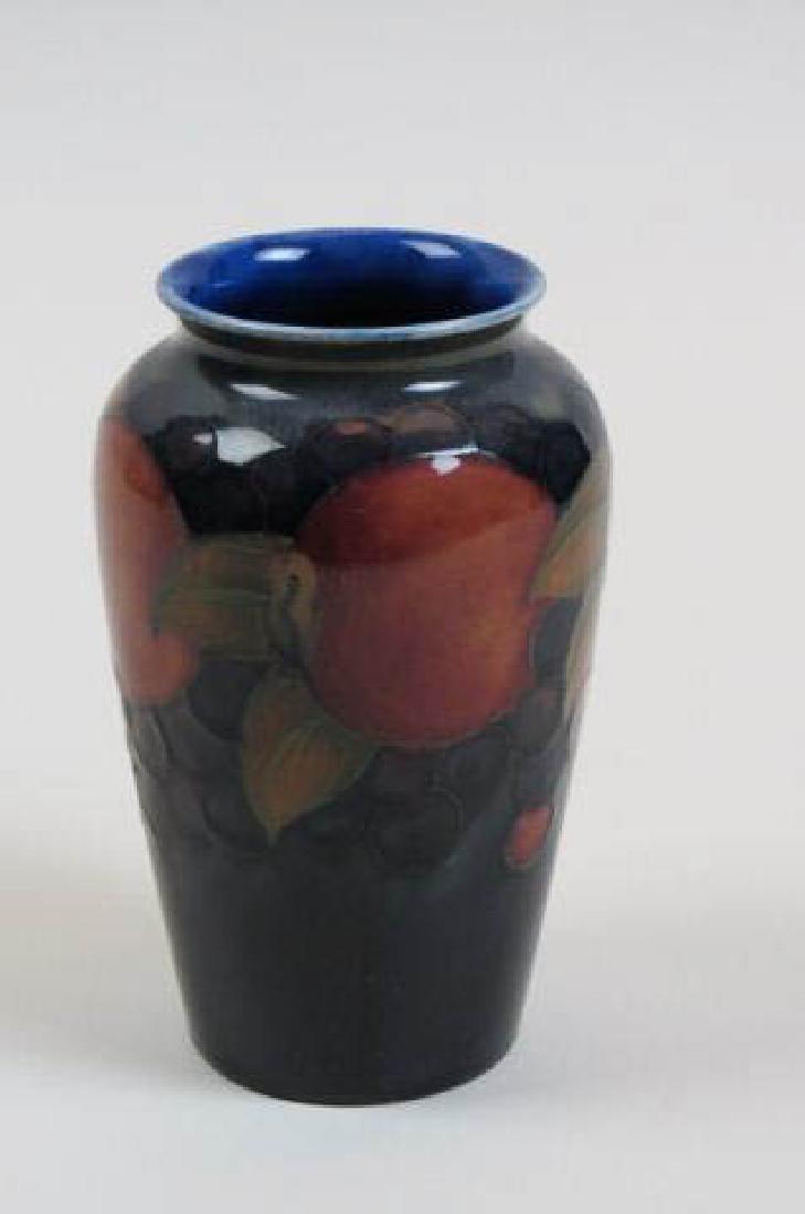 Moorcroft Art Pottery Vase,: pomegranate design on blue, 5" tall, excellent.......Moorcroft pottery was first made in Burslem, England, in 1913. William Moorcroft had managed the art pottery department for James Macintyre & Compa