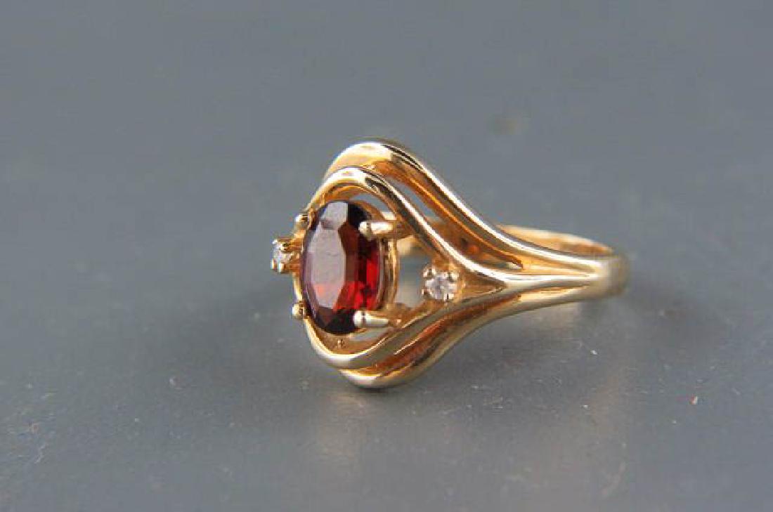 Garnet & Diamond 14K Gold Ring,: vivid oval garnet weighing over 1 carat with round diamond on each side in 14k yellow gold, currently size 6.
