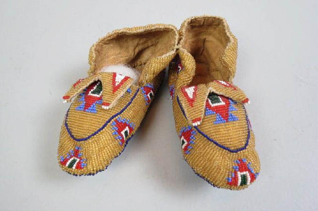 Native American Beaded Baby Moccasins,: elaborate overall beaded buckskin, 5 1/2" long, 2" wide, circa 1900, a fine pair.