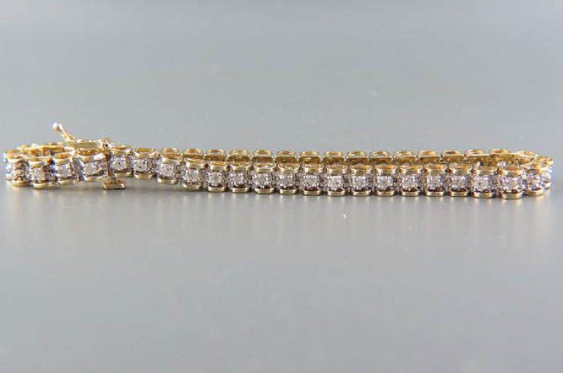 Diamond 14K Gold Bracelet,: 46 round diamonds totaling 2.48 carats in 14k yellow gold tennis or straight line style, with appraisal of $2005.00, 7 5/8" long.