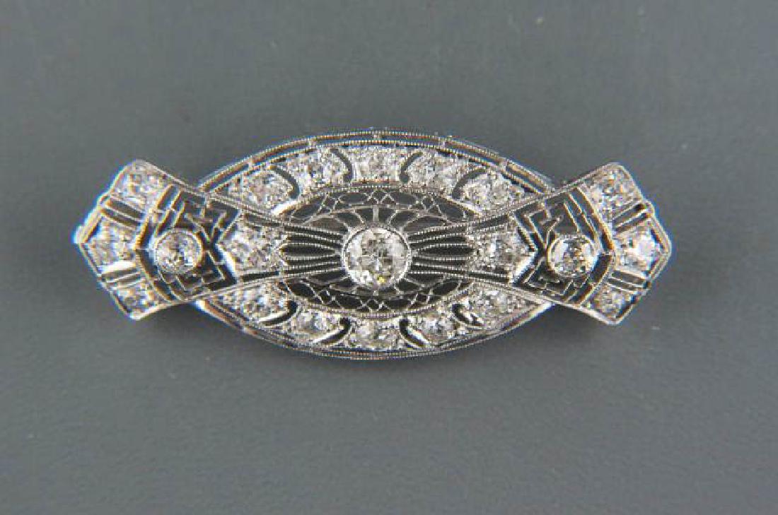 Antique Platinum & Diamond Brooch,: Art Deco, 13 round diamonds totaling 1.39 carat in filigree setting, with appraisal of $2755.00, 1 7/8 x 3/4".