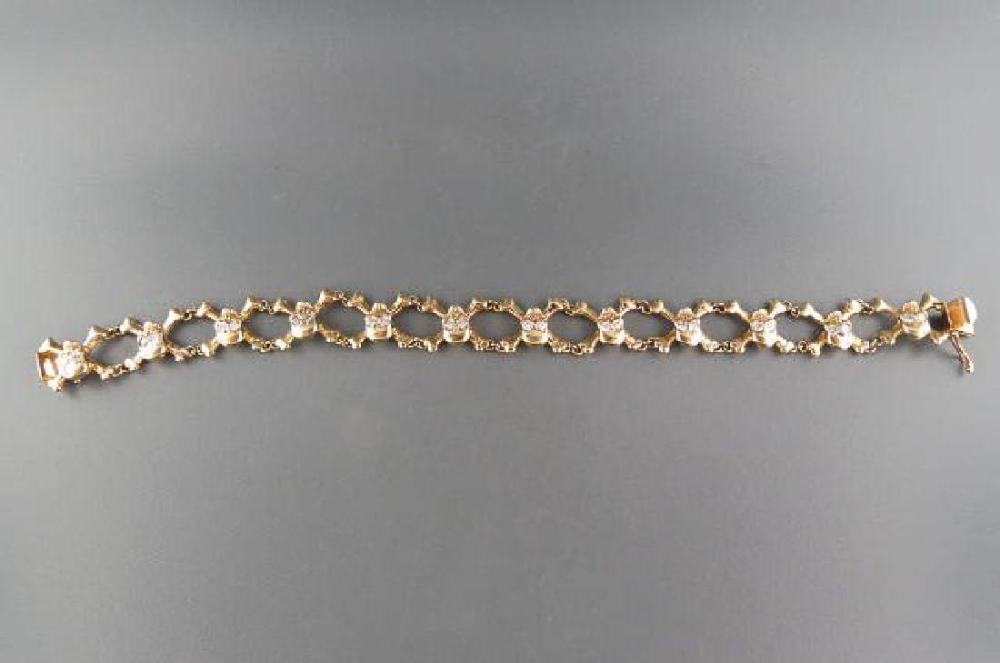 Diamond Bracelet with Skull & Crossbones,: unisex, 24 round diamonds totaling .70 carat in 14k yellow gold, 29.24 grams, with appraisal of $5055.00, 7 3/4" long.