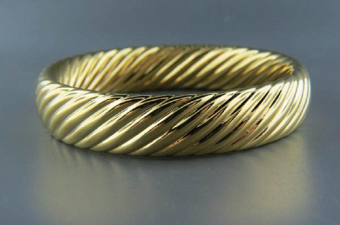 18k Gold Bangle Bracelet,: cable design, 5/8" wide, 2 5/8" opening across, yellow gold, resin filled (weighted), total 38 grams.