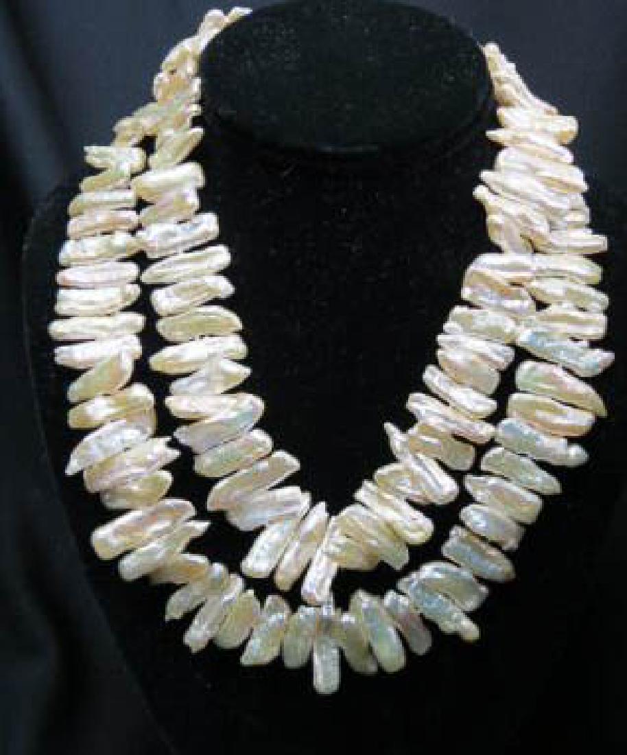 Pearl Necklace,: double strand of silvery pink & gold elongated river pearls, up to 19" long, sterling clasp.