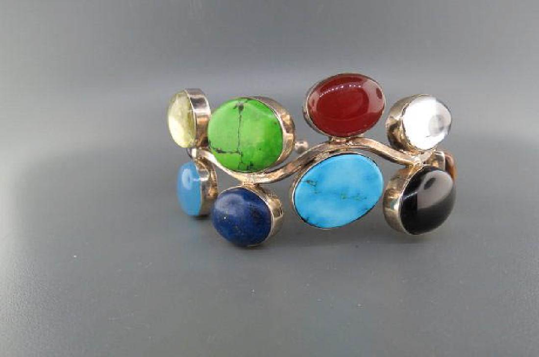 Gemstone & Sterling Silver Braccelet,: colorful cabochons including lapis, turquoise, amethyst, quartz, carnelian, onyx, tiger's eye, & more. 1 3/8" wide.