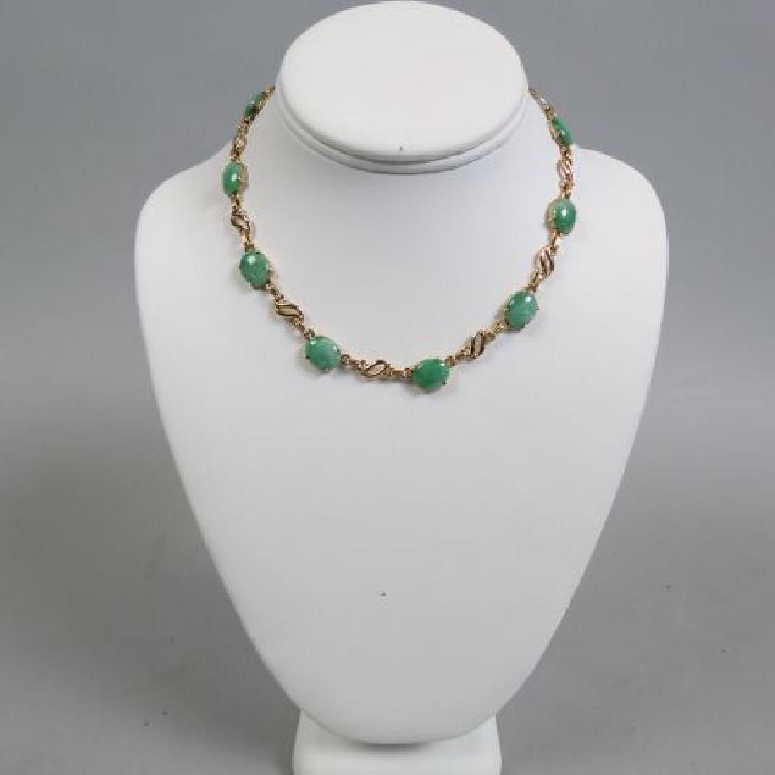 Jade & 14K Gold Necklace,: 10 oval jadeite cabochons, apple green, each 11.5 X 9.75 mm, totaling 14.56 carats, heavy 14K yellow gold, with appraisal of $2850.00, 15 1/4" long.