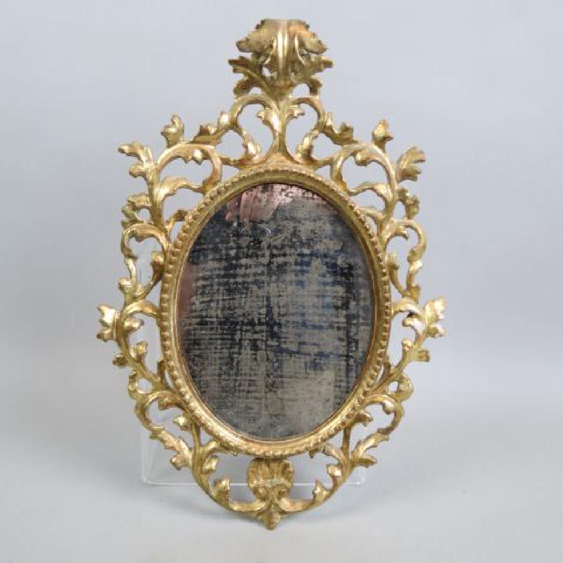 Italian Carved & Gilt Mirror,: oval rococo design, overall 18" X 12", oval image or mirror area is 8" X 10".