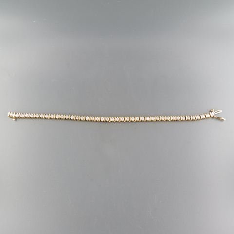 Diamond Bracelet,: 49 round diamonds totaling 2.50 carats in 14K yellow gold, straight line or tennis style, with appraisal of $4,500.00, 7" long.