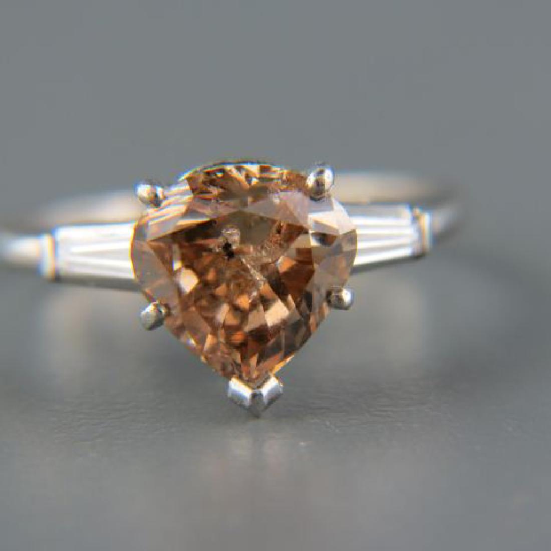 Fancy Pinkish Brown Diamond Solitaire Ring,: 2.19 carat pear shaped gem with tapered baguette on each side, in classic platinum mounting, with appraisal of $ 8405, currently size 4 3/4