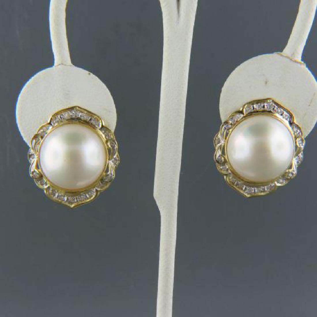 Mabe Pearl & Diamond Earrings,: 15.5mm pearls surrounded by diamonds in 14k yellow gold Omega pierced clip settings, overall 1" diameter