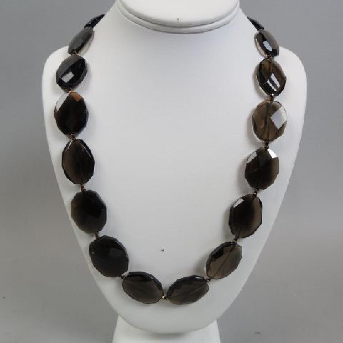 Smokey Quartz Necklace,: 28 oval faceted beads, 36" long, gold on sterling silver clasp