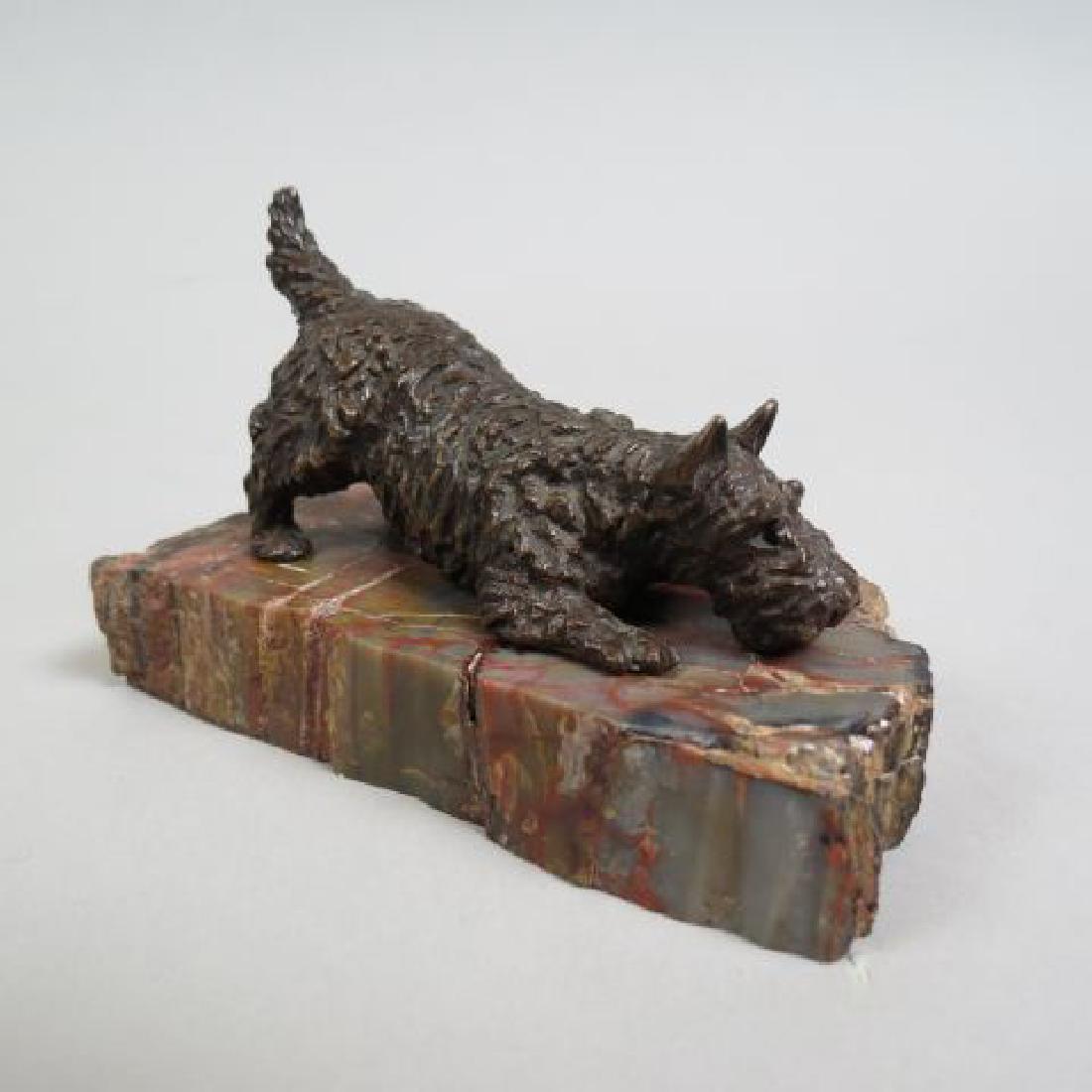 Marguerite Kirmse Bronze Figurine of a Scotty,: 3 1/4" long, 1 7/8" tall, well listed artist 1885-1954, accompanied by a petrified wood slab it sits upon...............Born in Bournemouth, England, December 14, 1885, of parents who operated a succe