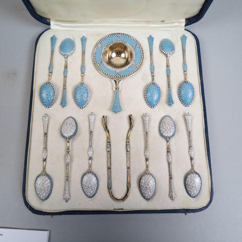 David Andersen Enameled Sterling Tea Serving Set: with gold gilt, famous Norway silversmith, cloisonne style blue and white enamel, includes tea strainer, tongs and twelve spoons, in original box.