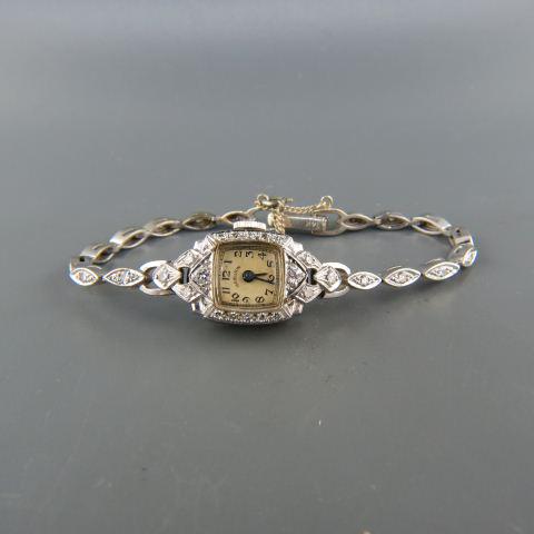 Hamilton Diamond Platinum & Gold Ladies Wristwatch: having 34 round diamonds totaling .95 carat, platinum case, 14K white gold band, 18 grams, with appraisal of $2,400.00, 7 1/4", working.