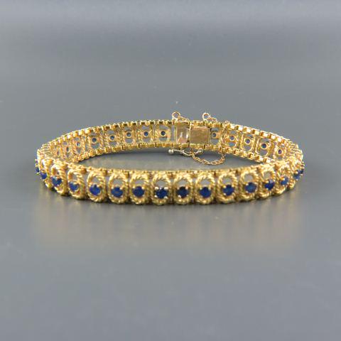 Sapphire 18K Gold Bracelet,: 35 round rich blue gems totaling 3.85 carats, yellow gold, 29.4 grams, with appraisal of $4,330.00, 8 1/4" long.