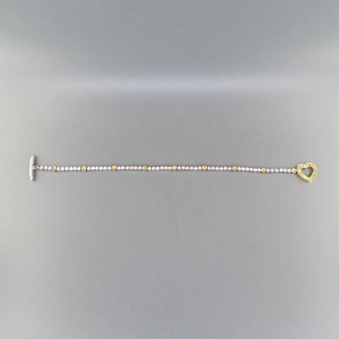 Diamond & Yellow Sapphire Bracelet,: heart and toggle clasp, 1.25 carats of gems all bezel set in 14K white gold, 7.5 grams, 7" long.