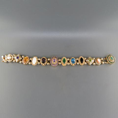 Diamond & Gemstone Gold Slide Bracelet,: eleven slides plus emerald clasp, includes peridot, blue topaz, opal, amethyst, citrine, garnet, pearl, cameo, onyx and more, 10K and 14K yellow gold, most are 5/8" wide, 40.7 grams, 7 1/4" long.