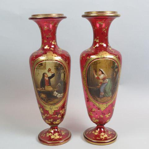 Pair of Moser Art Glass Enameled Scenic Vases,: on scene of young man drinking wine out of a canteen, other of young woman drinking water from a fountain, elaborate gold trim on rich cranberry, 17" tall, late 19th century, impressive
