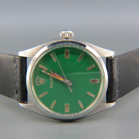 Rolex Man's Stainless Steel Wristwatch,: vintage, luministic hands, green after market dial, 34 mm across, black leather band, working.
