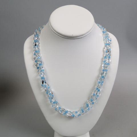 Aquamarine Necklace,: triple strand of oval beads with blue cut spacers, 14K yellow gold clasp, hundreds of carats of gems, 28" long.
