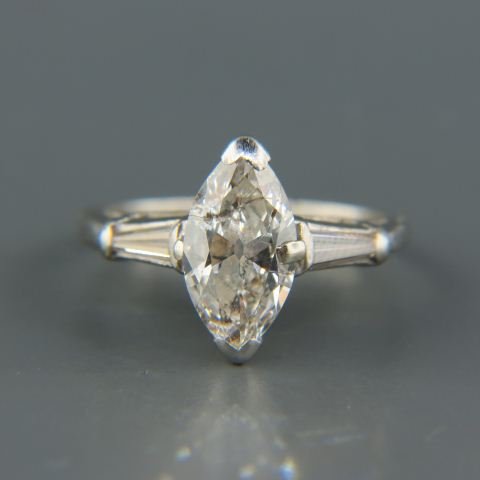 Diamond Solitaire Ring 2.10 carats in platinum setting,: marquise shape diamond, J color, I-2 clarity with tapered baguette on each side totaling another .51 carat, vintage platinum setting, with appraisal of $7380.00, currently size 6.