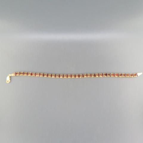 Garnet & 14K Gold Tennis Bracelet,: 32 square gems totaling over 5 carats in yellow gold, 8.2 grams, 8" long.